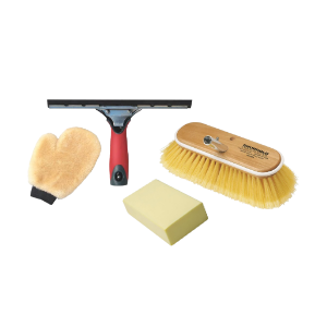Collection of various boat cleaning products sat behind a yellow sponge and a deck brush head