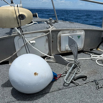 Active Anchors DF400 releasable marine anchor with chain and white buoy displayed on the deck of a fishing boat at sea.