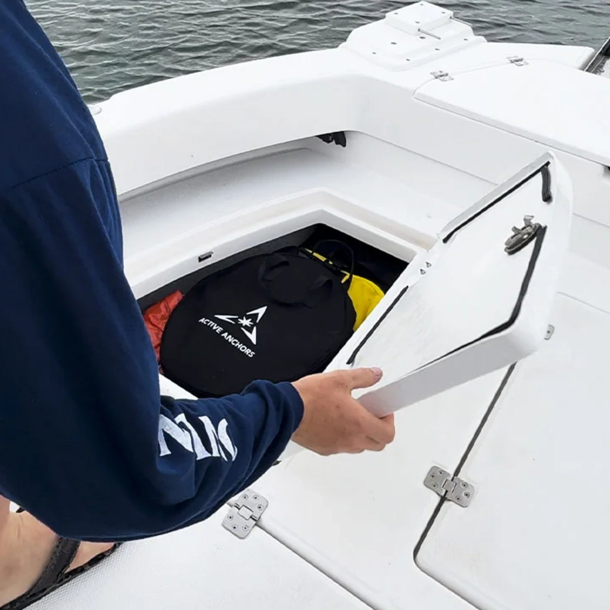Active Anchors DF400 black anchor carry bag stored inside the rear storage compartment of a recreational motorboat.