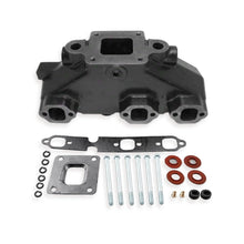 MAR612 Manifold for Mercruiser on a white background with various gaskets and fitting hardware.