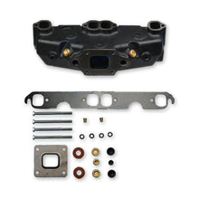 Exhaust manifold beside a gasket and some fitment hardware.