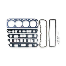 Gasket set including a headgasket, 4x intake and exhaust manifold gaskets, 2x valve cover gaskets and some washers, seals and hardware on a white background.