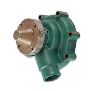 Green volvo penta water pump showing drive pulley and water outlet.