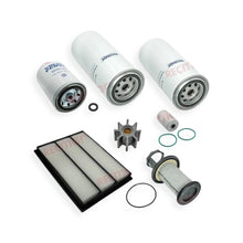 A set of marine engine filters and oil components arranged on a white background, including three cylindrical filters, a rectangular pleated filter, a metal pump or distributor-like part, gaskets, and O-rings.
