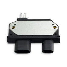 Black ignition module showing two plug connections and two metal pins at the top.