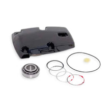 Black Mercruiser sterndrive top cap for upper unit with various seals and shims and a bearing on a white background.