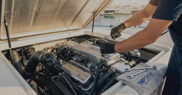 Image of a person working on a boat engine.